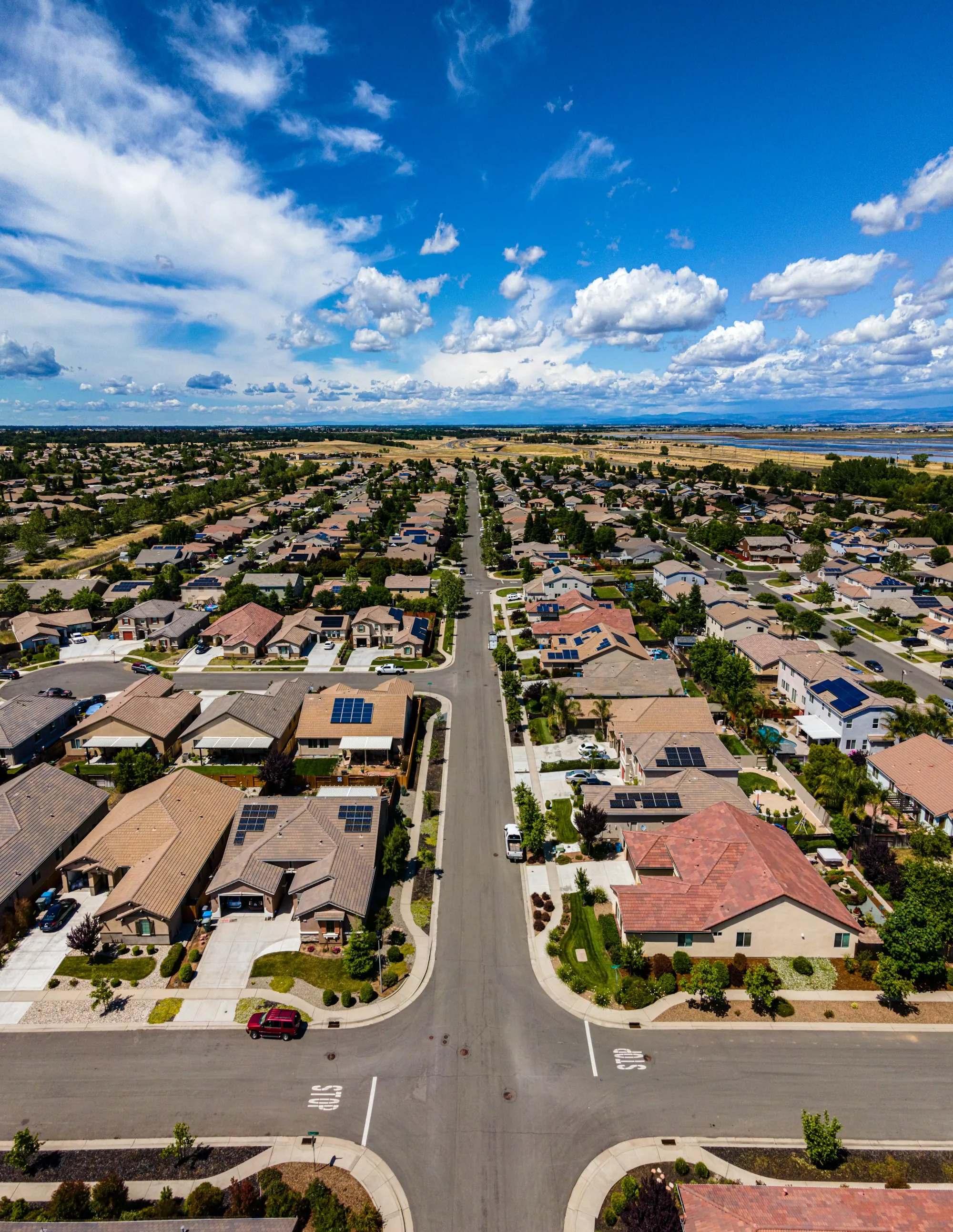 Aerial view of a suburban neighborhood under a blue sky